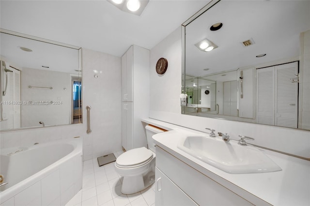 bathroom featuring tile patterned floors, toilet, tiled tub, and vanity