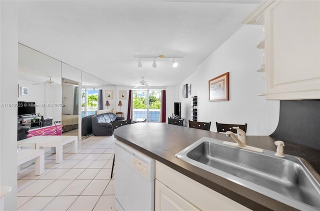 kitchen featuring sink, ceiling fan, track lighting, and white dishwasher