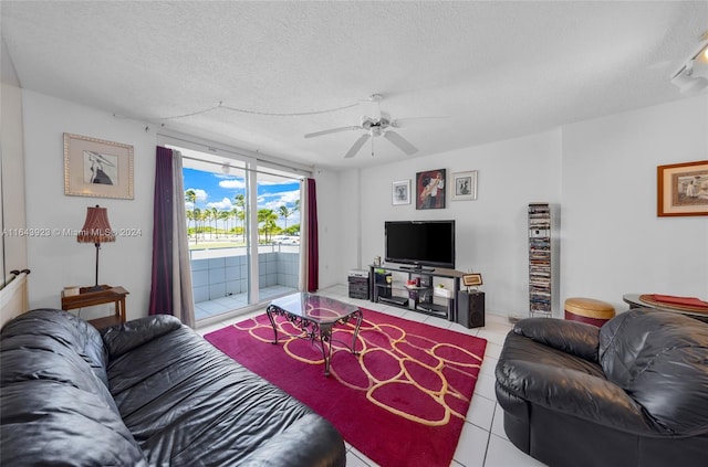 living room featuring tile patterned floors, a textured ceiling, and ceiling fan