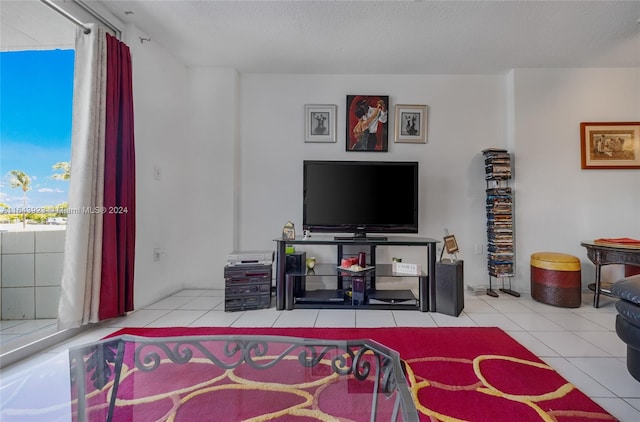 living room with a textured ceiling and light tile patterned floors