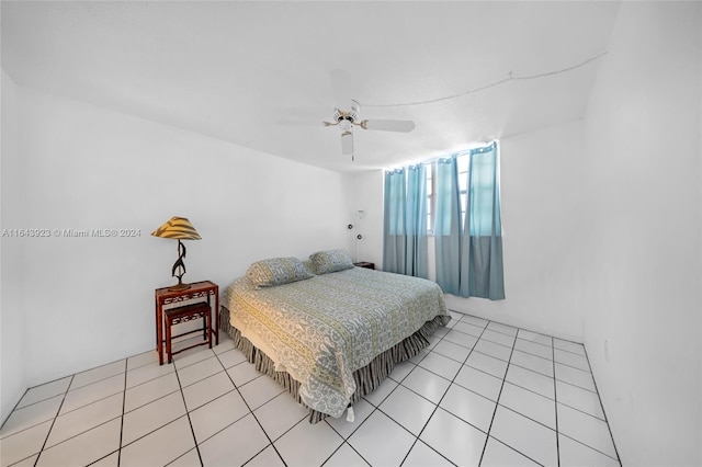 tiled bedroom featuring ceiling fan