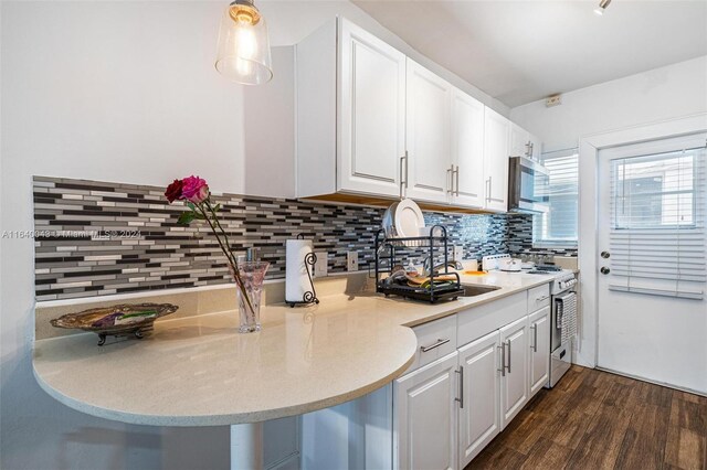 kitchen featuring decorative backsplash, white cabinetry, sink, range, and dark wood-type flooring