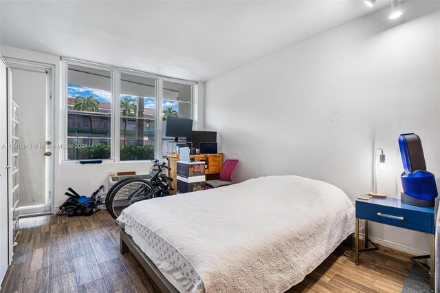 bedroom with wood-type flooring