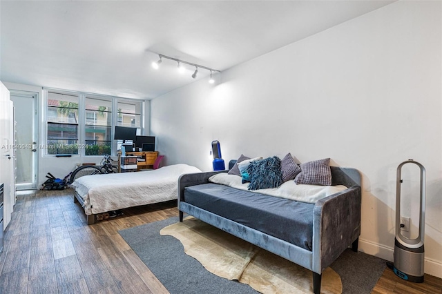 bedroom featuring track lighting and wood-type flooring