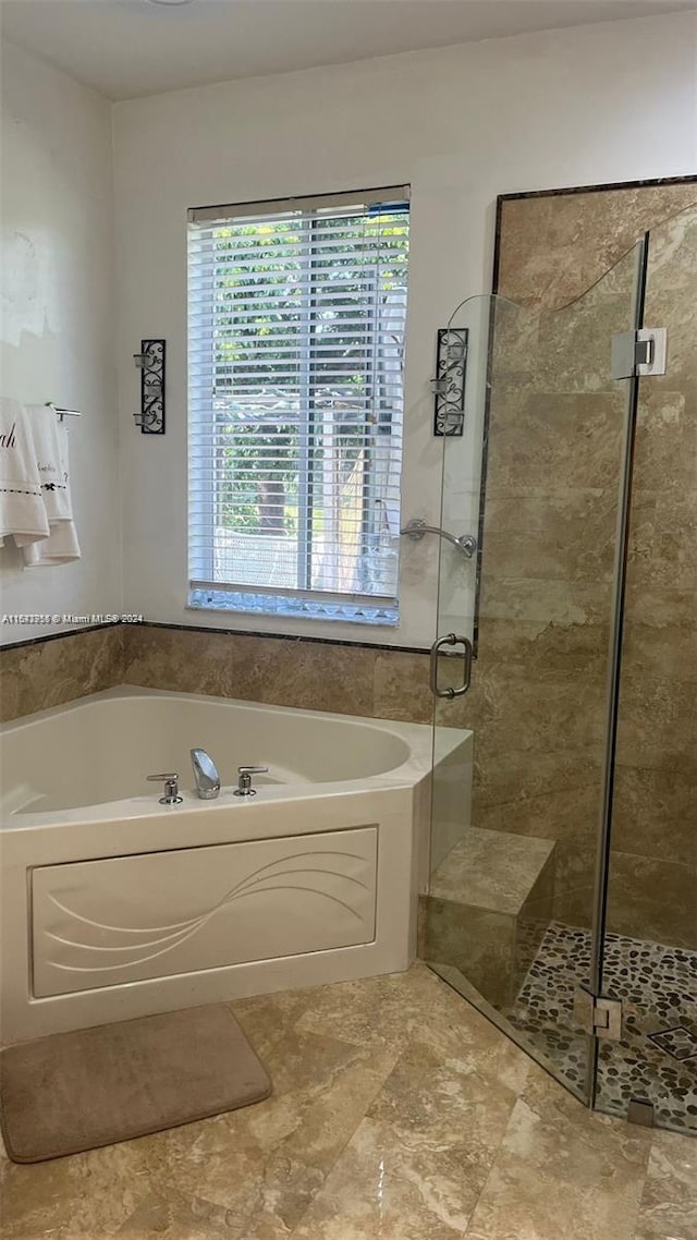 bathroom featuring plus walk in shower and tile patterned floors