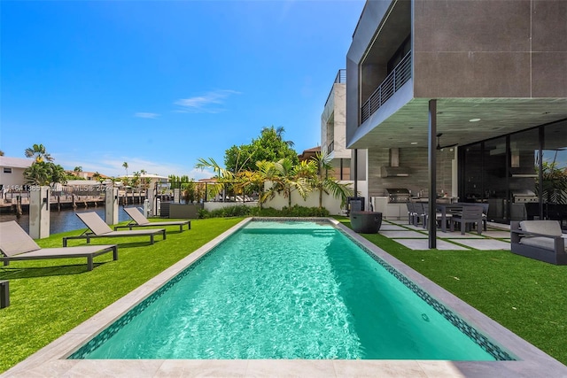 view of swimming pool with a patio and a lawn