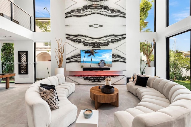 living room featuring a high ceiling and tile patterned flooring