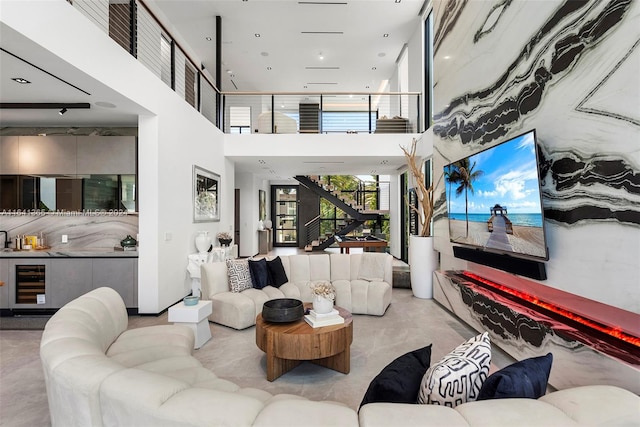 living room featuring wine cooler and a high ceiling