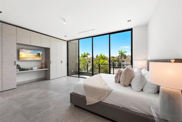 bedroom featuring access to outside and a wall of windows