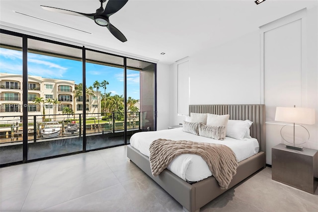 tiled bedroom with a wall of windows, ceiling fan, and access to outside