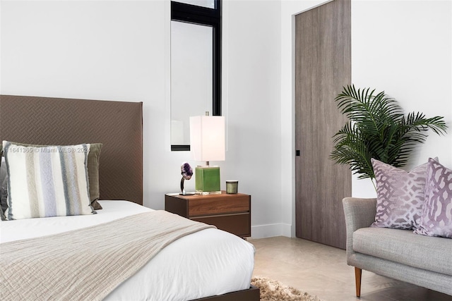 bedroom with light tile patterned floors and a closet