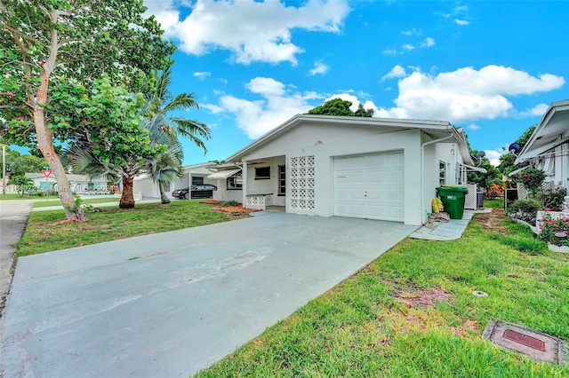 view of front of property with a garage and a front lawn