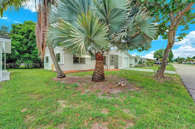 exterior space featuring a front lawn and a garage