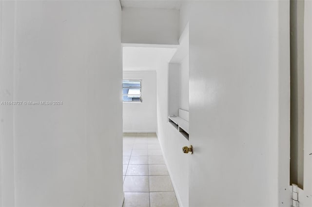 hall with light tile patterned floors