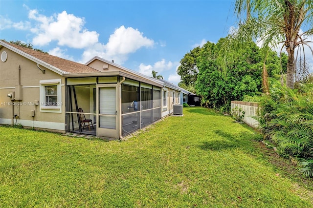 view of yard with a sunroom and central AC