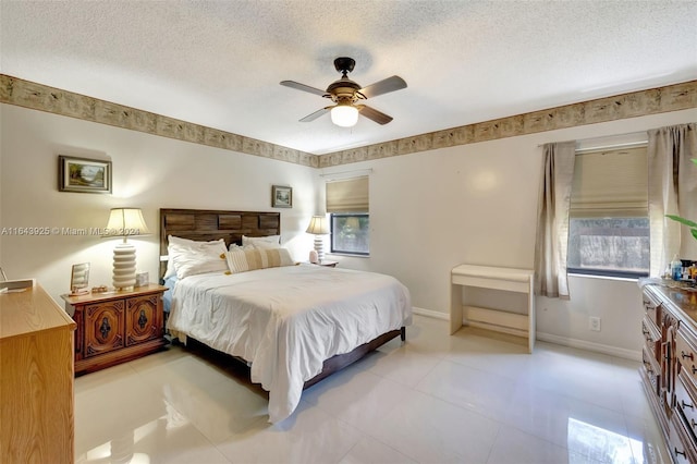 bedroom featuring a textured ceiling, ceiling fan, multiple windows, and light tile patterned floors