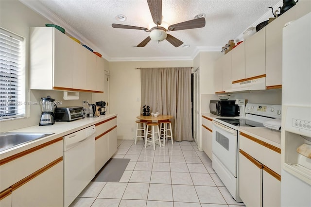 kitchen featuring ornamental molding, white cabinets, light tile patterned floors, white appliances, and ceiling fan