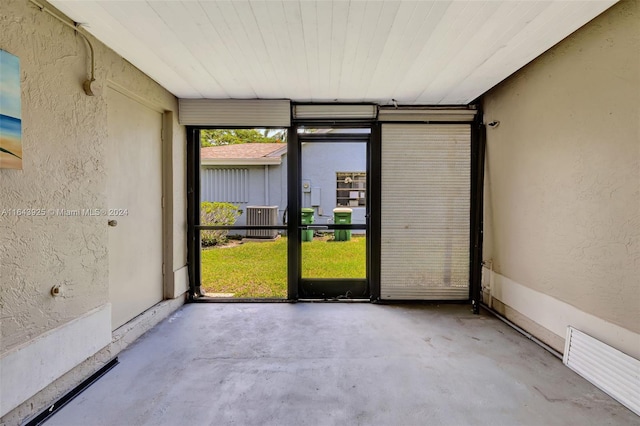 unfurnished room with concrete flooring