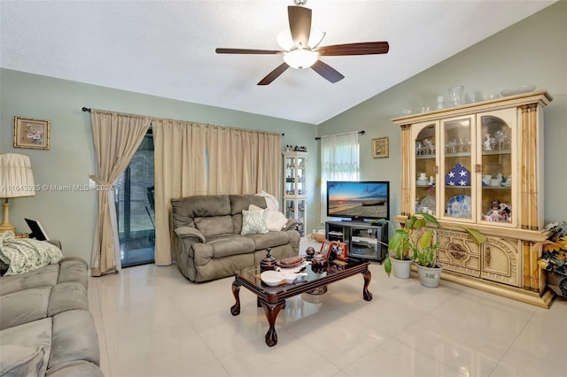 tiled living room with ceiling fan and lofted ceiling