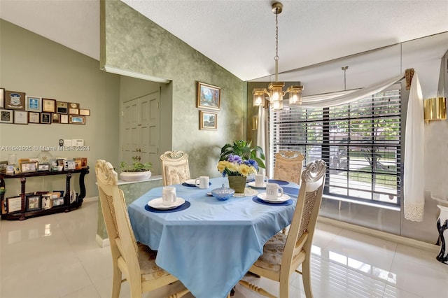 dining area featuring light tile patterned floors, vaulted ceiling, and a notable chandelier