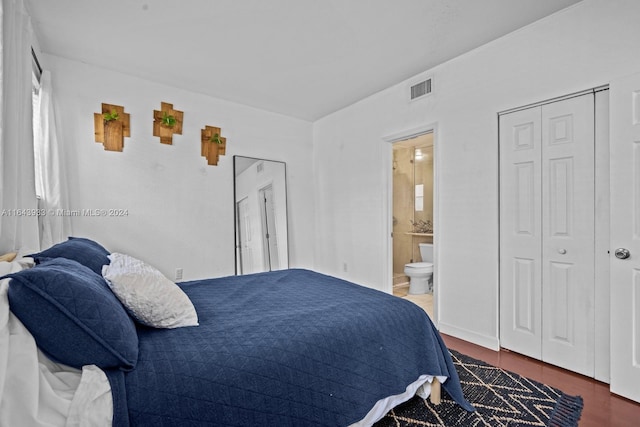 bedroom featuring wood-type flooring and connected bathroom