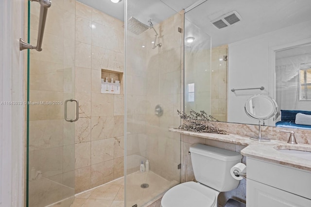 bathroom featuring toilet, a shower stall, visible vents, and vanity