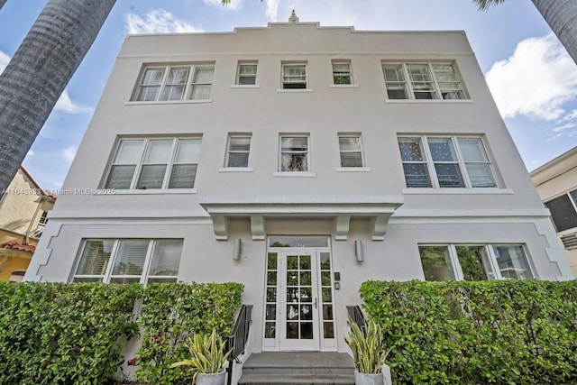 view of front facade with entry steps and stucco siding