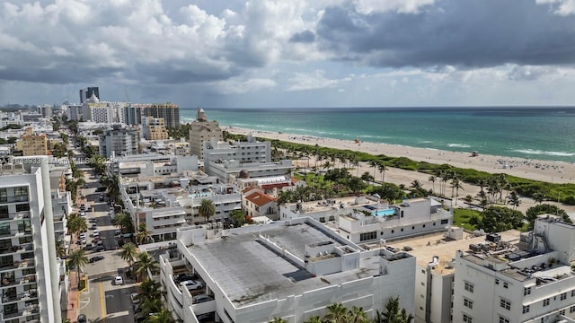 aerial view featuring a view of the beach, a water view, and a city view