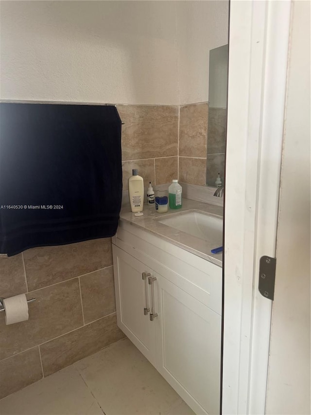 bathroom with tile patterned flooring and vanity