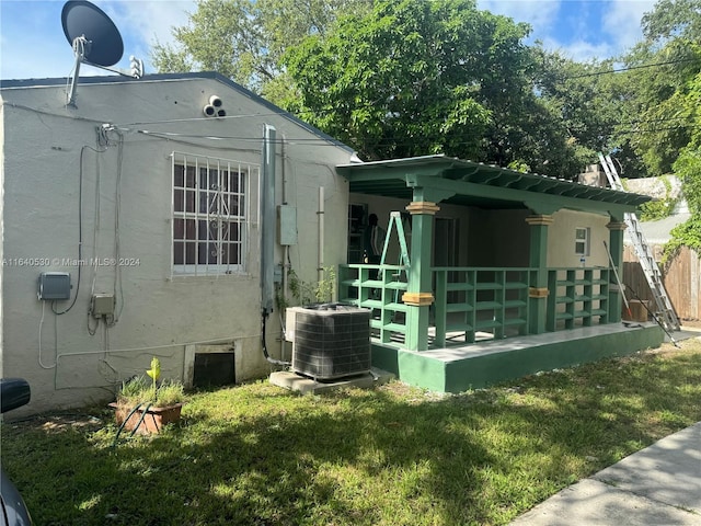 exterior space with a lawn and cooling unit