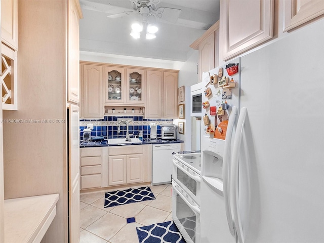 kitchen featuring light tile patterned flooring, sink, white appliances, light brown cabinetry, and ceiling fan