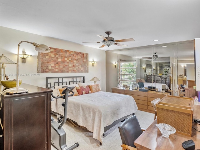 bedroom featuring ceiling fan and carpet