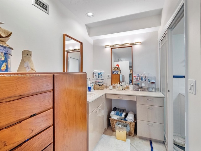 bathroom featuring tile patterned flooring and vanity