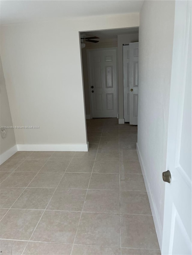 corridor with light tile patterned floors