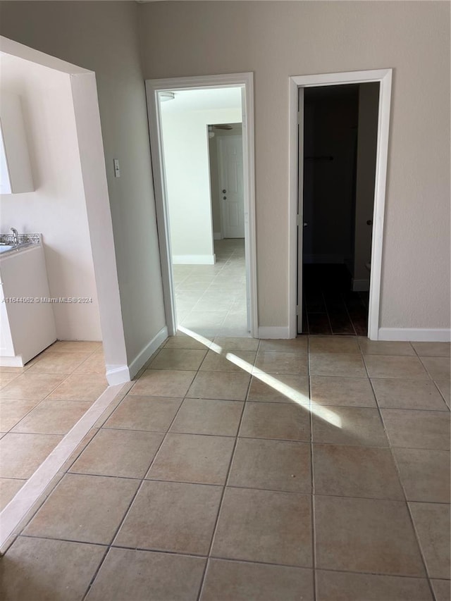 hall featuring light tile patterned flooring