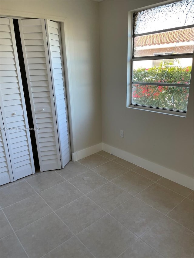 unfurnished bedroom featuring a closet and tile patterned floors