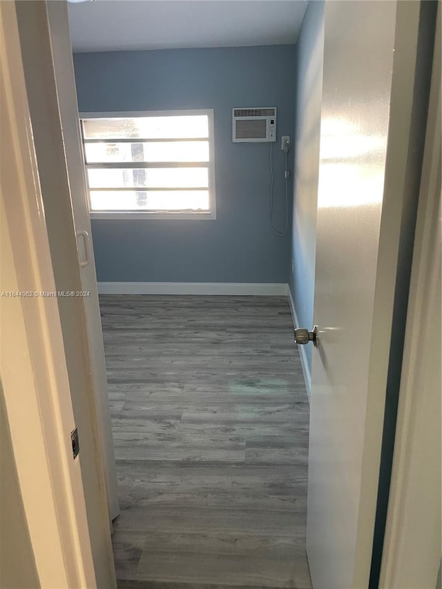 spare room with dark wood-type flooring and a wall mounted AC