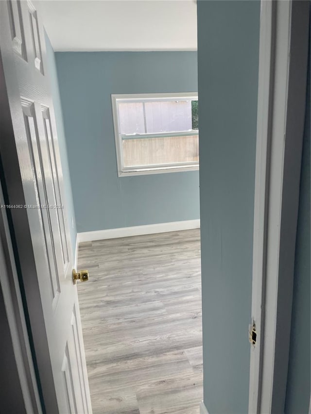 empty room with light hardwood / wood-style flooring