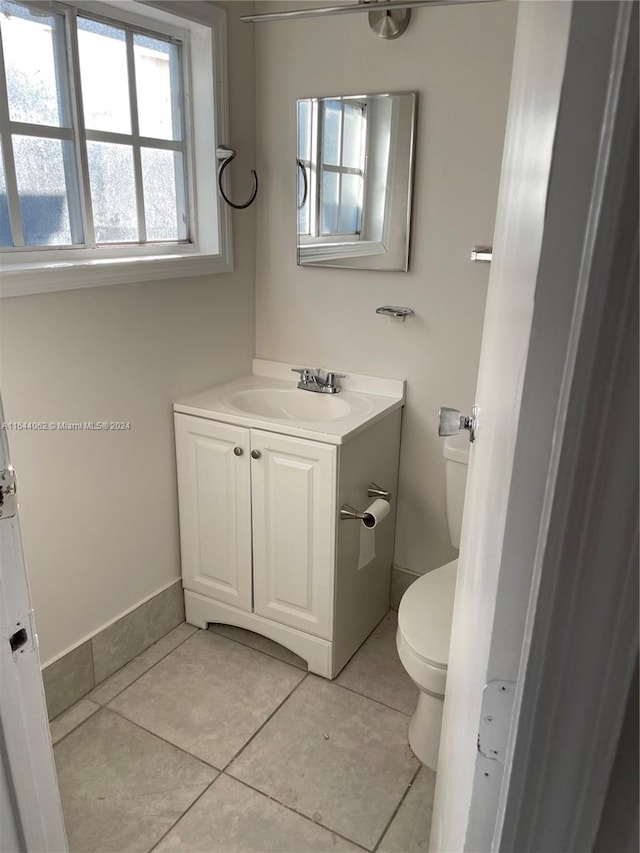 bathroom featuring tile patterned flooring, vanity, and toilet