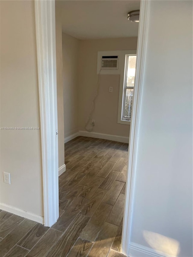 hallway featuring dark wood-type flooring and a wall mounted AC