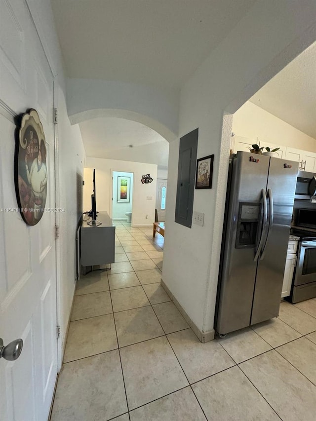 corridor featuring light tile patterned floors and electric panel