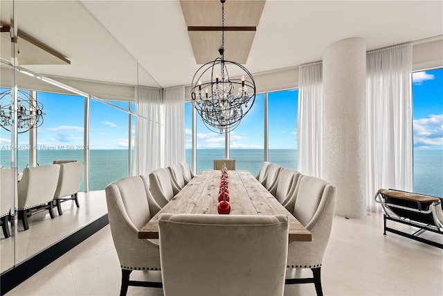 tiled dining space featuring a notable chandelier and a water view