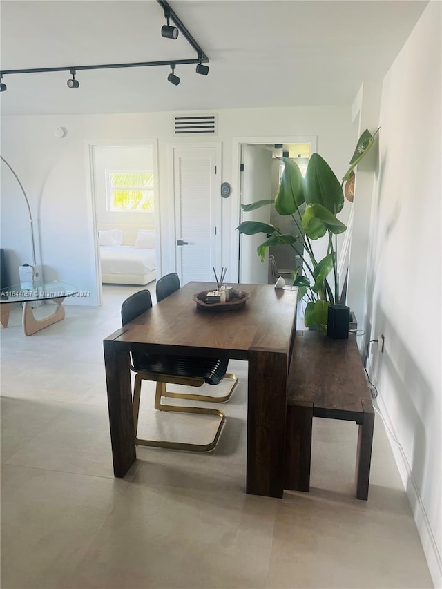 dining room featuring track lighting