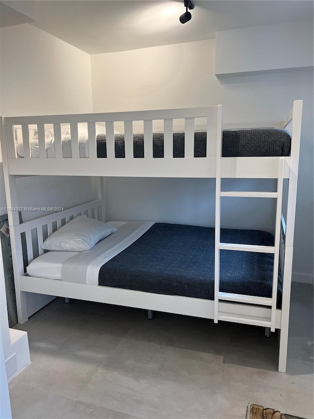 bedroom featuring concrete flooring