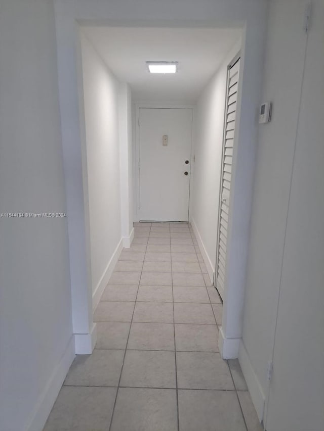 hallway featuring light tile patterned floors