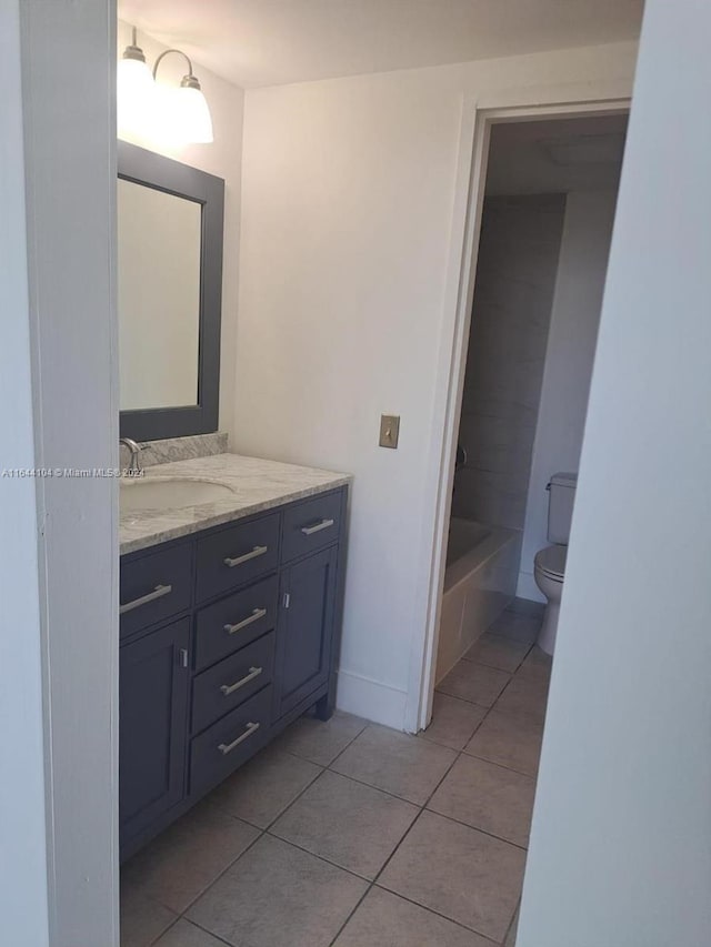 full bathroom with tile patterned flooring, toilet, vanity, and shower / washtub combination