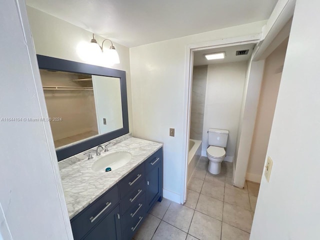 bathroom featuring toilet, tile patterned floors, and vanity