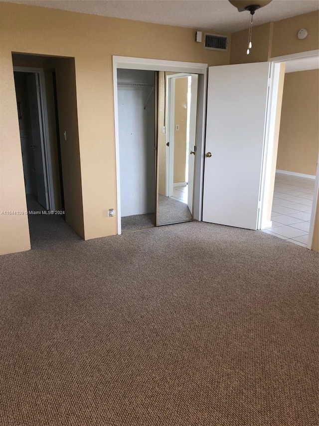 unfurnished bedroom featuring a closet and carpet floors