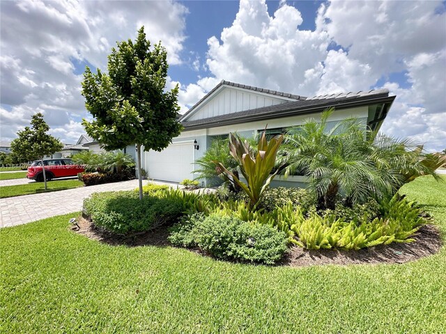 view of home's exterior featuring a garage and a lawn