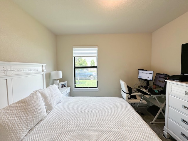 bedroom featuring dark colored carpet